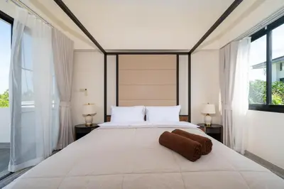 a bedroom with a large white bed with two lamps at Luxury 5 bed Laguna Park no Pool in Laguna Phuket