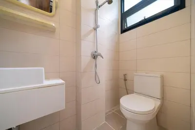 a bathroom with a toilet and a sink and a window at Luxury 5 bed Laguna Park no Pool in Laguna Phuket