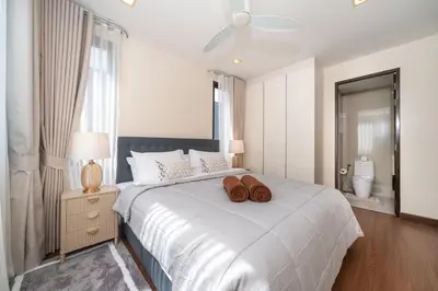 a bedroom with a bed with two brown shoes on it at Luxury 5 bed Laguna Park no Pool in Laguna Phuket
