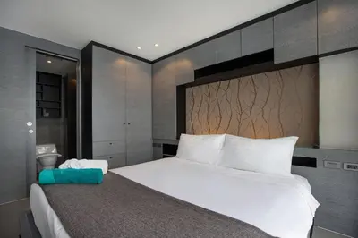 a bedroom with a large white bed with a large headboard at 2 BR Pool View in Wellness Residence near Beach P503-4 in Kamala Beach