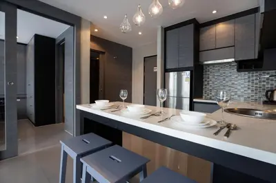 a kitchen with a counter with glasses of wine at 2 BR Pool View in Wellness Residence near Beach P503-4 in Kamala Beach