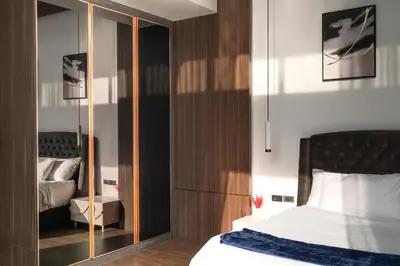a bedroom with a bed and a mirrored cabinet at Prestige 4BR Private Pool Residence in Rawai in Ban Kata