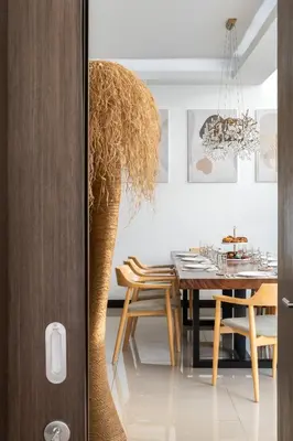 a dining room with a table and a vase at Prestige 4BR Private Pool Residence in Rawai in Ban Kata