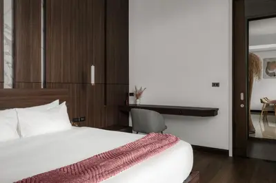 a bedroom with a bed and a desk and a chair at Prestige 4BR Private Pool Residence in Rawai in Ban Kata