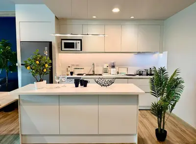 a kitchen with white cabinets and a white counter top at Family apartment 2-BR with Sea View - Karon Beach in Ban Karon