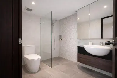 a bathroom with a toilet and a sink and a shower at Santosa Hotel & Welness Center in Ban Kata