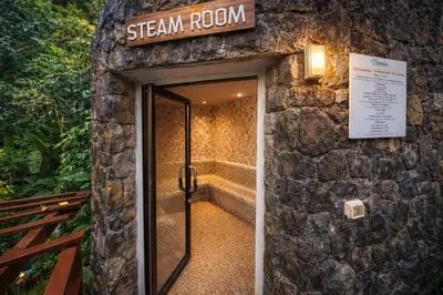 a stone building with a sign that reads steam room at Santosa Hotel & Welness Center in Ban Kata