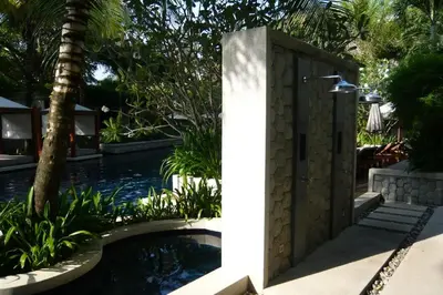 a swimming pool with a shower in a garden at Beachfront 2 BR Luxury Condominium Surin in Surin Beach