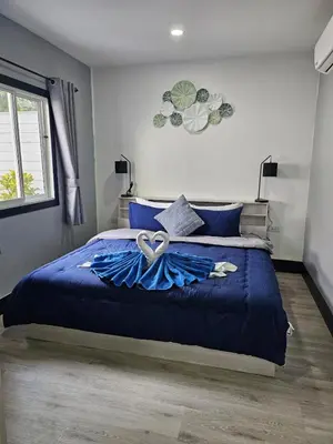 a bedroom with a blue bed with a bow on it at Life & Beauty Villa 400m To Beach - Sleeps 7 in Ban Lum Fuang