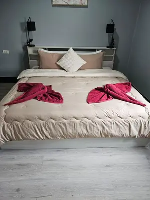 a bed with two red towels on it at Life & Beauty Villa 400m To Beach - Sleeps 7 in Ban Lum Fuang