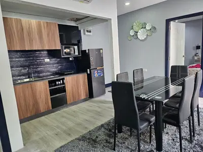 a dining room with a black table and chairs at Life & Beauty Villa 400m To Beach - Sleeps 7 in Ban Lum Fuang