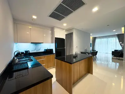 a kitchen with a black counter top in a room at The Pelican Residence & Suites Krabi in Ban Ko Kwang