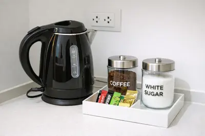 a black tea kettle and a container of coffee and a candle at The View Condo Monthly Stay Near Central Phuket 30 Day Minimum in Ban Rangeng