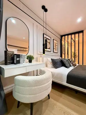 a bedroom with a bed and a chair and a mirror at The View Condo Monthly Stay Near Central Phuket 30 Day Minimum in Ban Rangeng