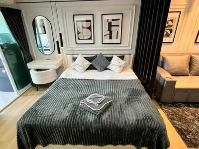 a bedroom with a bed and a couch in it at The View Condo Monthly Stay Near Central Phuket 30 Day Minimum in Ban Rangeng