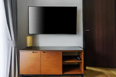 a flat screen tv sitting on top of a entertainment center at The Title Condo 2BR by G Estate Phuket in Phuket Town