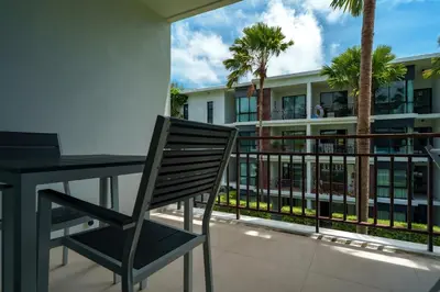a chair sitting at a table on a balcony at The Title Condo 2BR by G Estate Phuket in Phuket Town