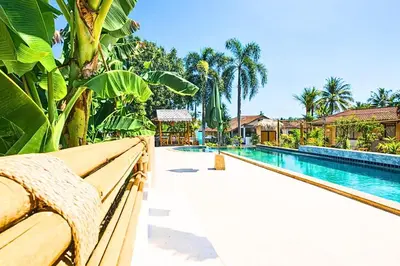 a view of a swimming pool with a resort at Tom Star Pool Villa Layan in Thalang