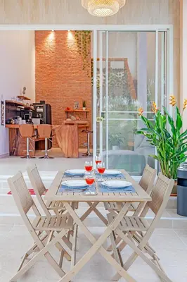 a wooden table and chairs in a living room at Tom Star Pool Villa Layan in Thalang