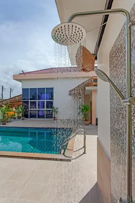 a water fountain in front of a house at Tom Star Pool Villa Layan in Thalang