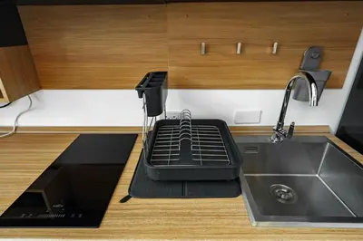 a kitchen with a sink and a drying rack at Lili Villa by G Estate Phuket in Nai Harn Beach