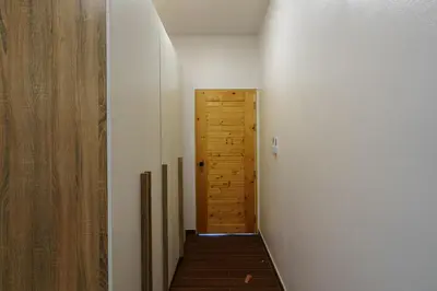 a hallway with a door and a wooden floor at Lili Villa by G Estate Phuket in Nai Harn Beach