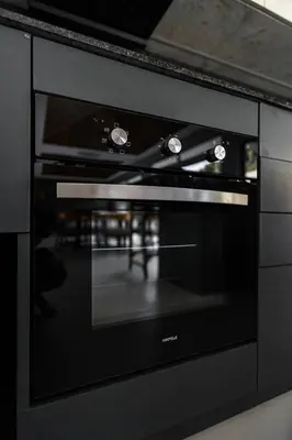 a black oven with its door open in a kitchen at Ramon Villa by G Estate Phuket in Ban Saiyuan (1)