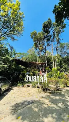 a sign that says mulai in a parking lot at House Party of Lee in Ban Huai Sai