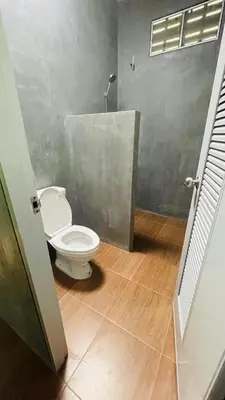 a bathroom with a white toilet in a room at House Party of Lee in Ban Huai Sai