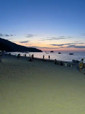 a group of people on a beach at sunset at 1 BDR 5 Swimming Pool Entire Condo 5 Mins Walk To Naiyang Beach in Nai Yang Beach