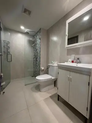 a bathroom with a toilet and a sink and a shower at 1 BDR 5 Swimming Pool Entire Condo 5 Mins Walk To Naiyang Beach in Nai Yang Beach