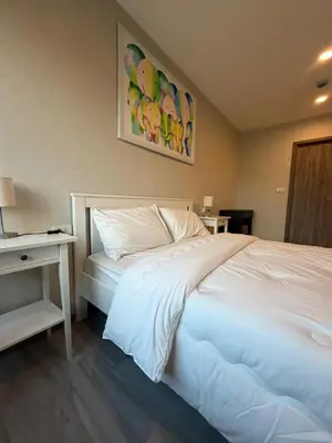 a bedroom with a large white bed with a table at 1 BDR 5 Swimming Pool Entire Condo 5 Mins Walk To Naiyang Beach in Nai Yang Beach