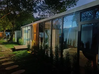 a glass house with a lot of windows at NeOtel Apartments in Ban Saiyuan (1)