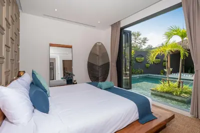 a bedroom with a large bed and a swimming pool at Cocoon Villa 6 - Eden Escape 3 BR - Pool - Garden in Ban Sakhu