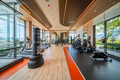 a gym with treadmills and elliptical machines at Canvas Cherngtalay Holiday Apartments in Laguna Phuket