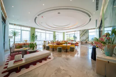 a lobby with couches and tables in a building at Canvas Cherngtalay Holiday Apartments in Laguna Phuket