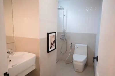 a bathroom with a shower and a toilet and a sink at Breeze House Patong in Patong Beach