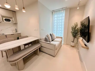a living room with a couch and a table at Breeze House Patong in Patong Beach