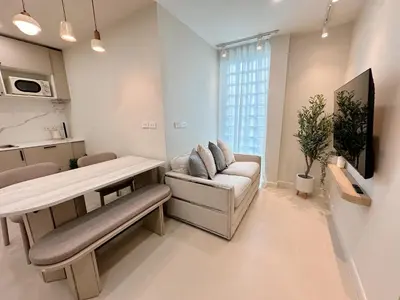 a living room with a couch and a table at Breeze House Patong in Patong Beach
