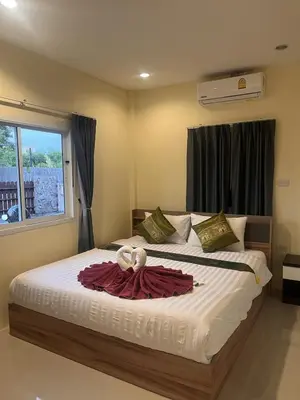 a bedroom with a bed with a towel on it at Cozy 2-Bedroom Place in a Quiet Area Nearby Beach in Ban Lum Fuang