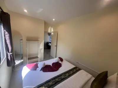 a small bedroom with a bed in a room at Cozy 2-Bedroom Place in a Quiet Area Nearby Beach in Ban Lum Fuang
