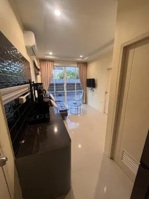 a living room with a black counter and a window at Cozy 2-Bedroom Place in a Quiet Area Nearby Beach in Ban Lum Fuang