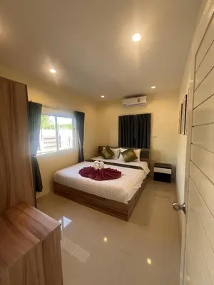 a bedroom with a bed and a window at Cozy 2-Bedroom Place in a Quiet Area Nearby Beach in Ban Lum Fuang