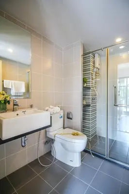 a bathroom with a toilet and a sink and a shower at Vista Residence Old Town in Phuket Town