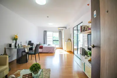 a living room with a bed and a dining room at Vista Residence Old Town in Phuket Town