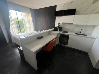 a white kitchen with a sink and a counter at Studio for rent in Rawai Beach