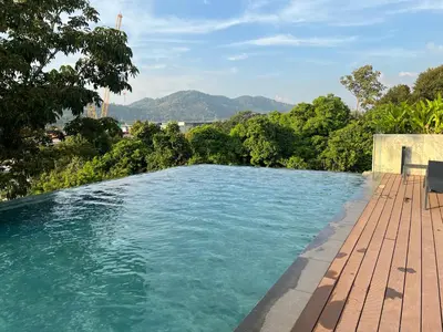 a swimming pool with a view of the mountains at Studio for rent in Rawai Beach