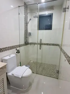a bathroom with a glass shower and a toilet at Stunning 3 Bedroom pool villa in Ban Thalat Choeng Thale