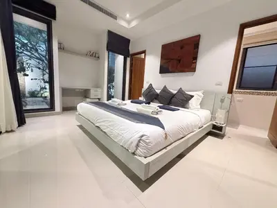 a large white bedroom with a large bed in it at Stunning 3 Bedroom pool villa in Ban Thalat Choeng Thale