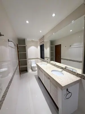 a bathroom with two sinks and a toilet at Stunning 3 Bedroom pool villa in Ban Thalat Choeng Thale